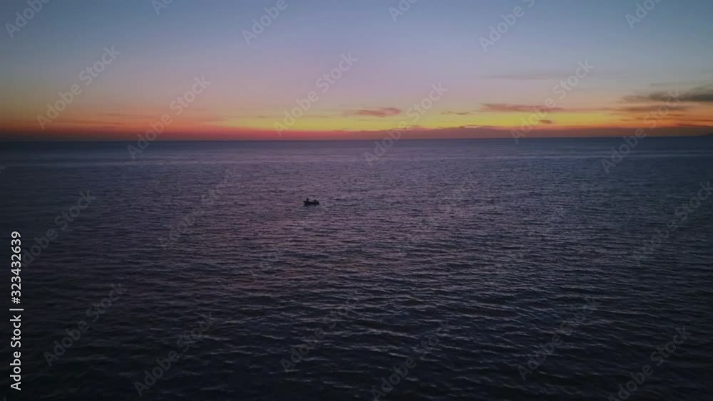 Fishing boat sailing on the Mediterranean sea after beautiful sunset near Italian town aerial top view 4K Fishing boat sailing on the Mediterranean sea after beautiful sunset near Italian town aerial top view 4K