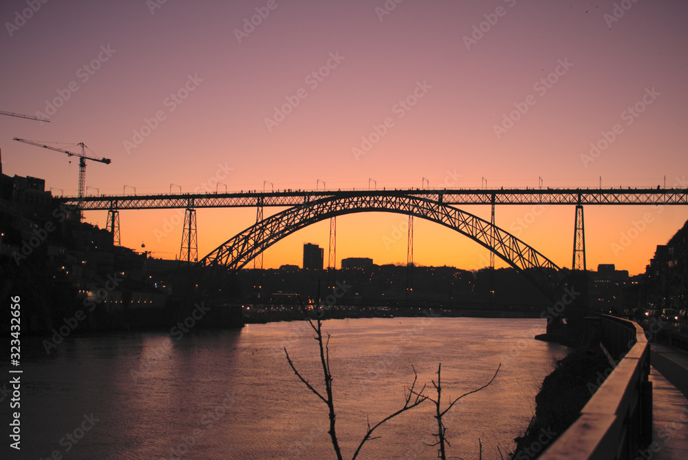 Purple and Orange sunset Dom luis Bridge in Porto Portugal