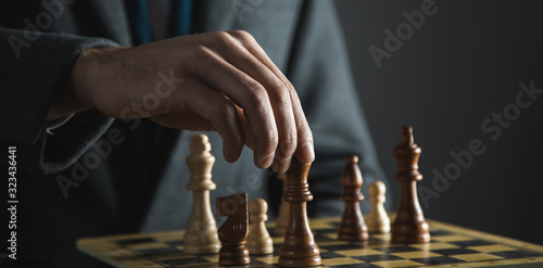 hands confident businessman colleagues playing chess game