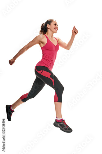 Portrait of active healthy young woman running on white background