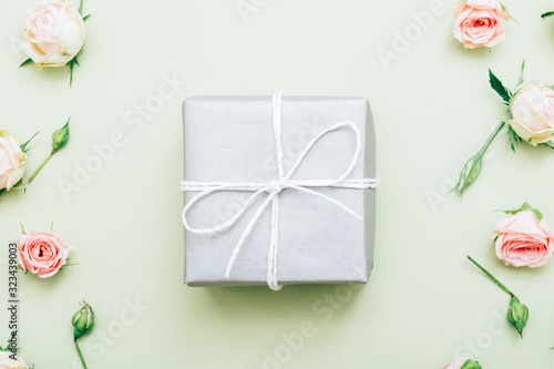 Holiday present. Festive occasion surprise. Silver gift box on floral pattern background.