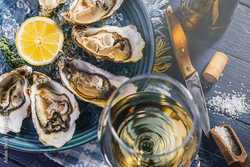 Fresh oysters with lemon ice and white wine. photo