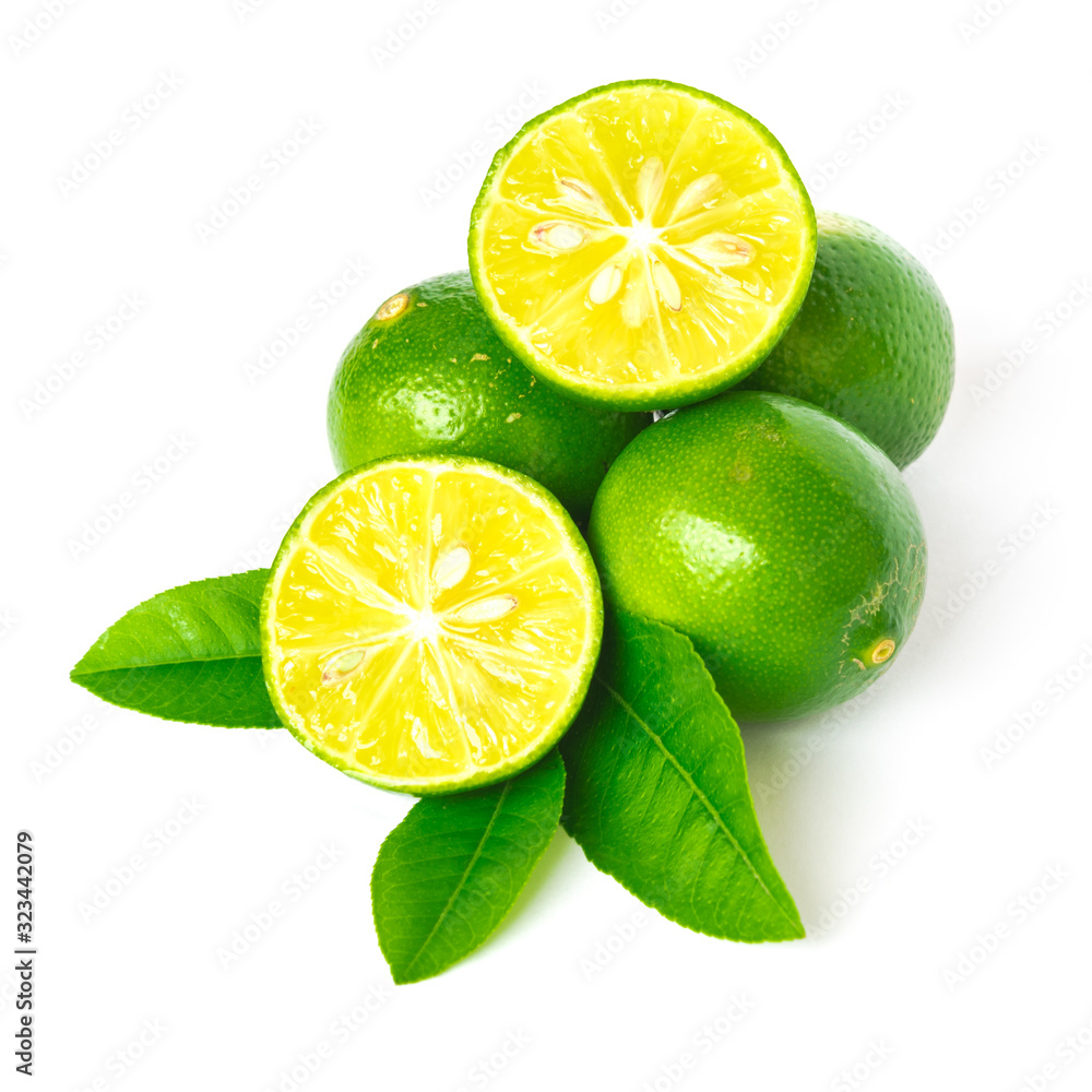Pile of homegrown Asian limes with half cuts slices and green leaves isolated on white