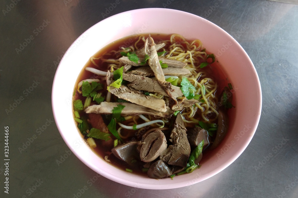 Duck noodle in a stainless steel table top bowl Duck noodle in a stainless steel table top bowl