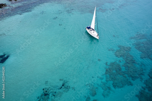 Aerial drone photo of luxury sail boat cruising in the deep blue mediterranean sea, Crete Greece