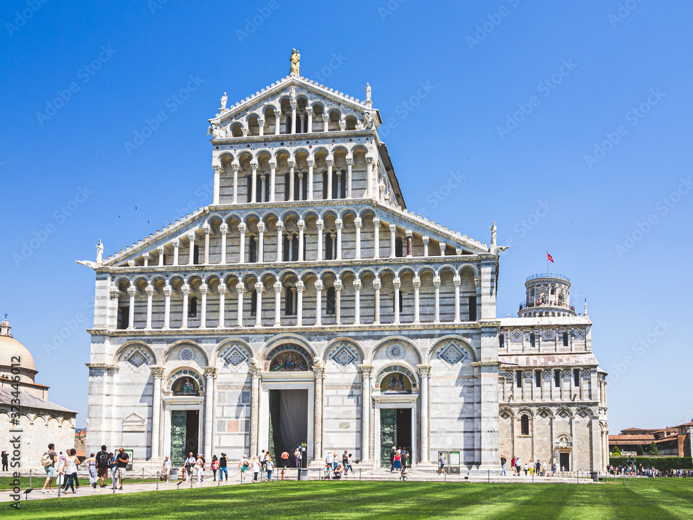 View of the tourists in front of the Pisa tower and the Pisa Cathedral