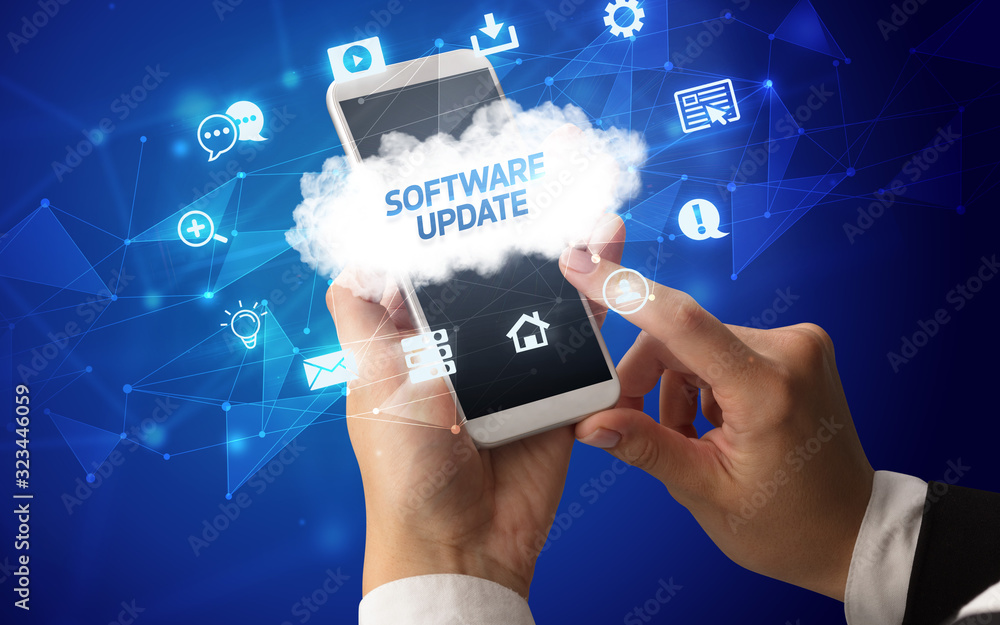 Female hand holding smartphone with SOFTWARE UPDATE inscription, cloud technology concept Female hand holding smartphone with SOFTWARE UPDATE inscription, cloud technology concept