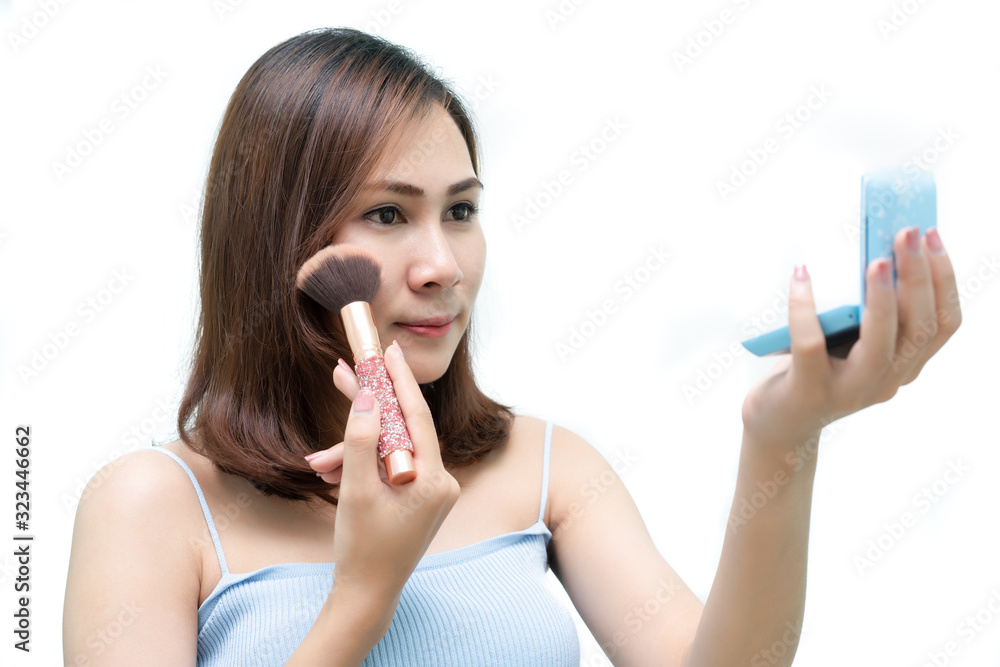 Healthy fresh girl use cosmetic to makeup her face. Beauty woman makeup her face with with cosmetic isolated on white background. Skin care and beauty concept. Healthy fresh girl use cosmetic to makeup her face. Beauty woman makeup her face with with cosmetic isolated on white background. Skin care and beauty concept.