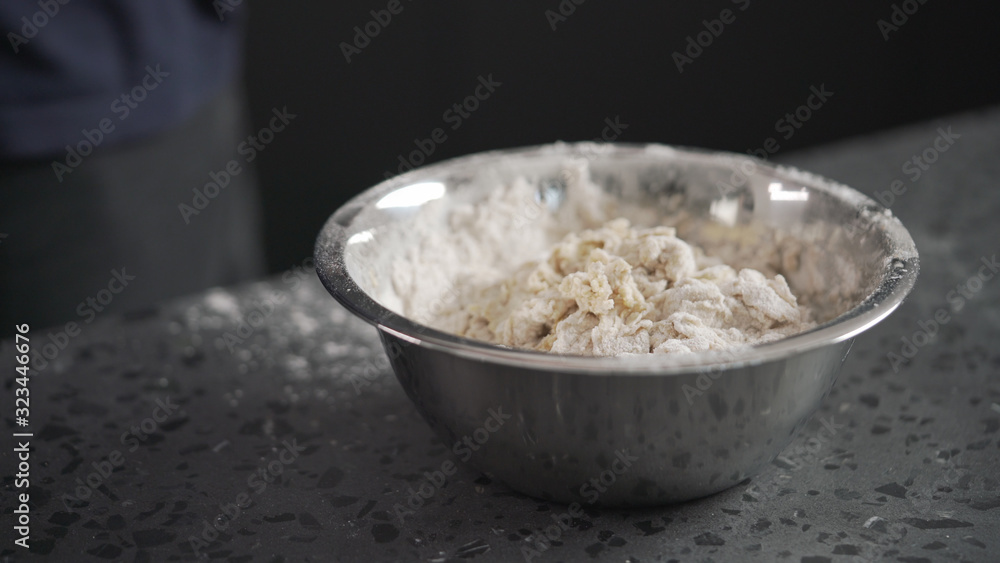 dough in steel bowl on concrete countertop dough in steel bowl on concrete countertop