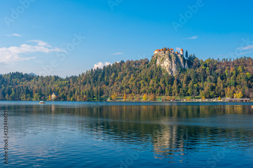 Picturesque view of the famous Bled castle on peak of hill on clear day. Autumn. Slovenia, Europe. Travel landscapes and landmarks concept. .