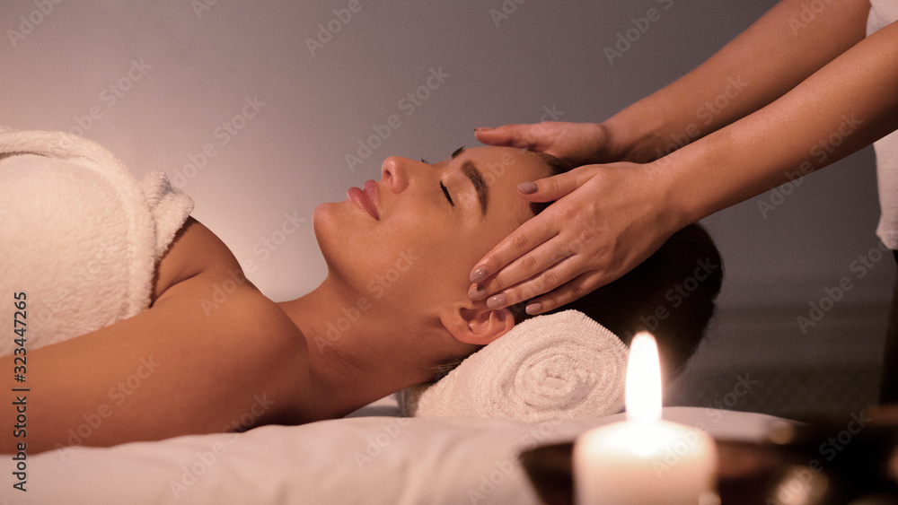 Spa treatment. Young woman enjoying face massage Spa treatment. Young woman enjoying face massage