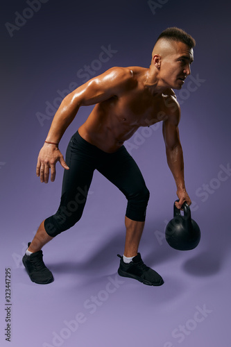 muscular strong athlete breaking his record, full length photo. isolated blue background, studio shot