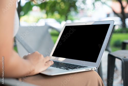 Close up Asian freelance girl working with a laptop.