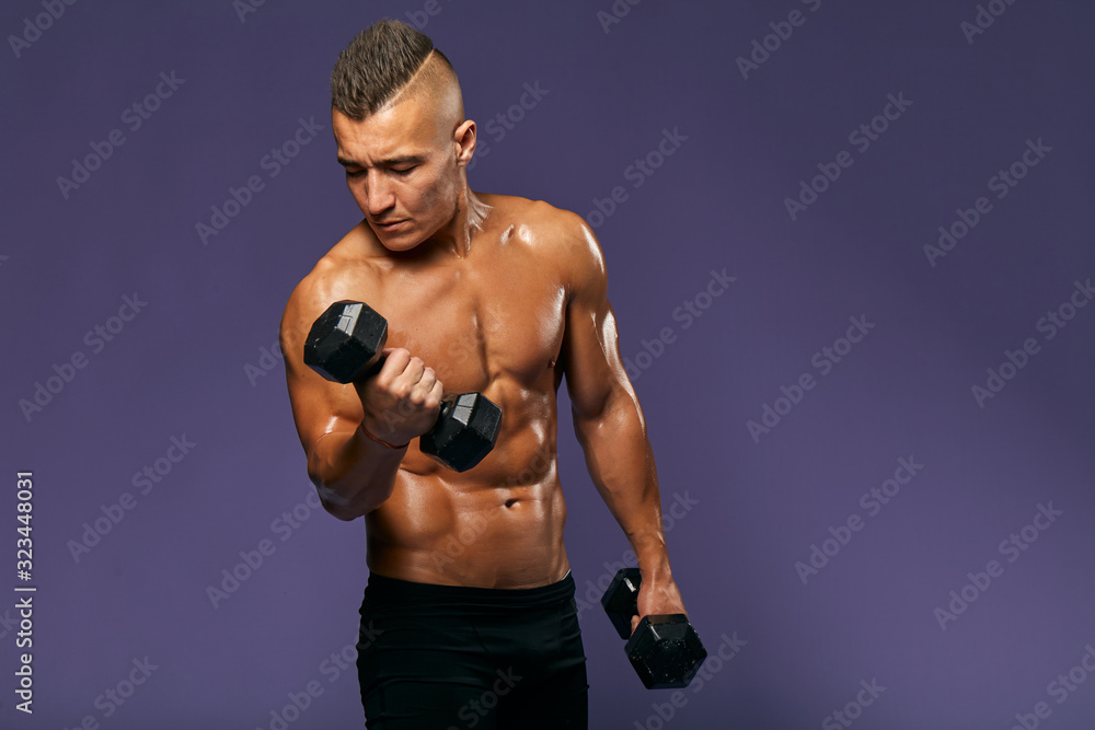 young sexy man is fond of bodybuilding. close up portrait, isolated blue background, professional, amature sport. close up portrait, studio shot, copy space