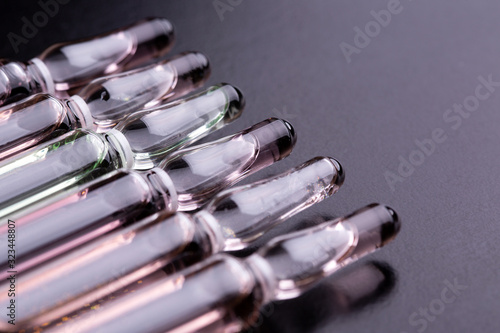 Ampoules on the table. Glass ampoules close up. photo
