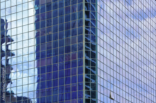 Abstract architecture. Glass blue square Windows of facade modern city business building skyscraper. The texture of the windows of the building.