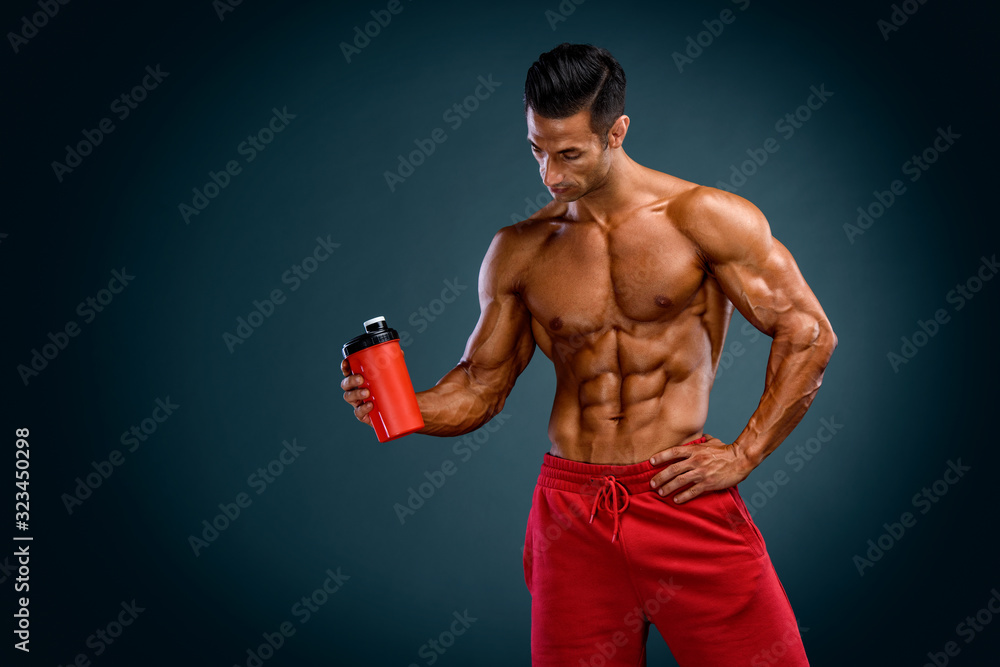 Nutritional Supplement. Muscular Men Drinks Protein, Energy Drink After Workout. Copy Space