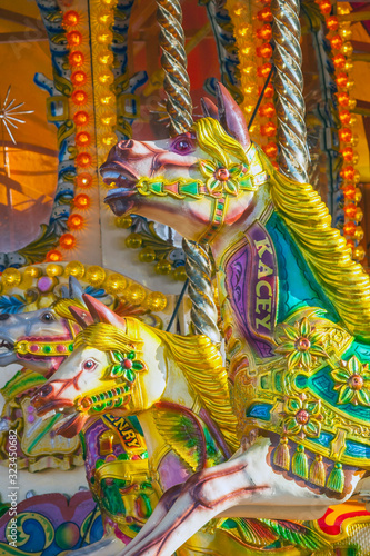 Brightly coloured carousel horses at fairground