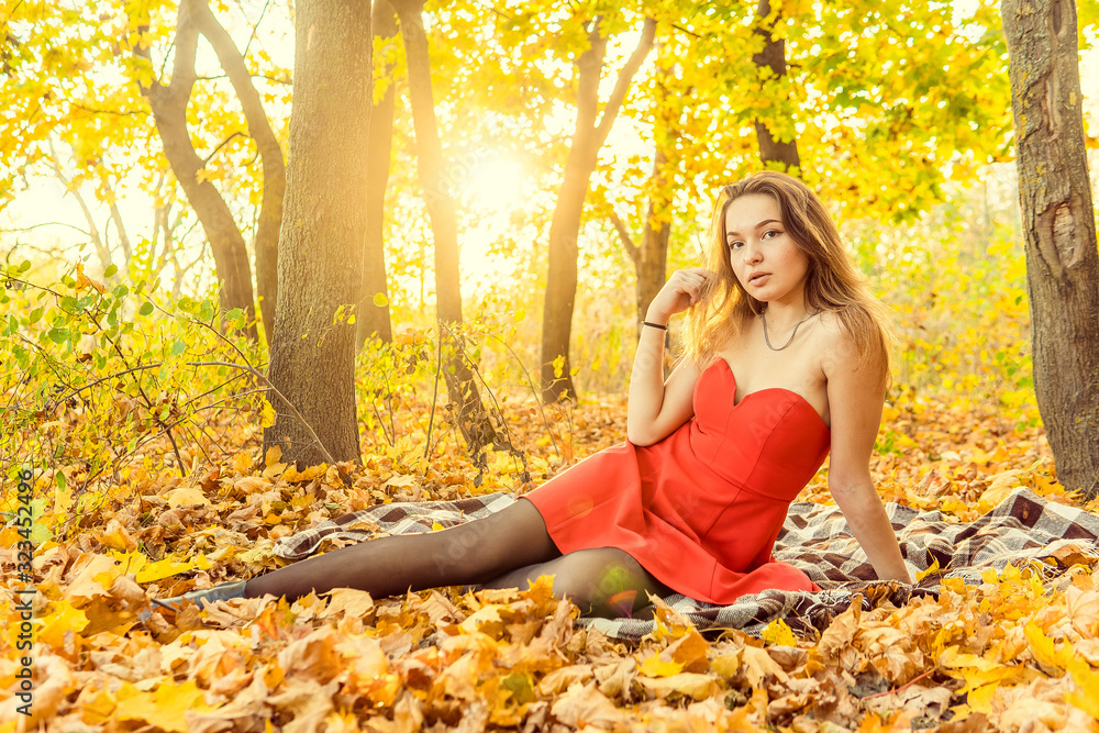 A woman is posing in front of a camera in an autumn park. autumn photo shoot. Autumn in the park. A woman is posing in front of a camera in an autumn park. autumn photo shoot. Autumn in the park.