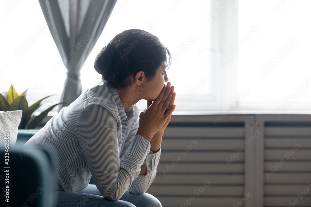 Pensive indian girl lost in thoughts suffering from depression