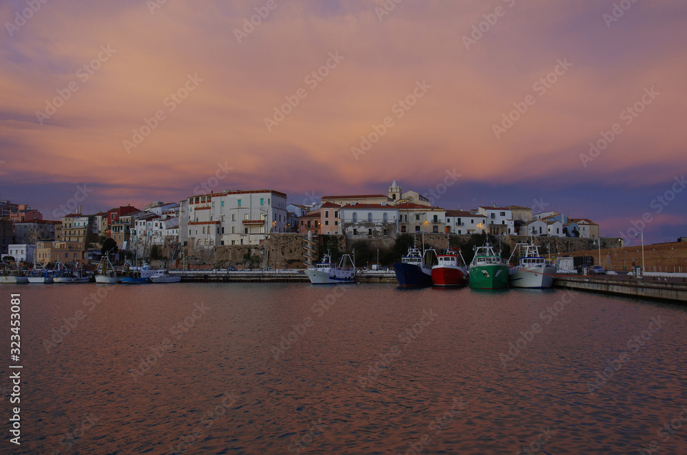 Fototapeta premium The harbor with fishing boats and in the background the old village, Termoli, Molise, Italy