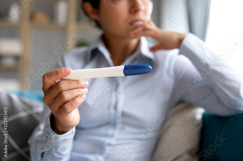 Young woman hold ovulation test waiting for results