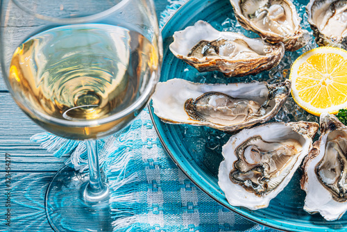 Canvas Print Fresh oysters with lemon ice and white wine.