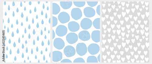 Set of 3 Cute Abstract Geometric Vector Patterns. White Tiny Hearts on a Gray Background.Blue Raindrops on a White.Irregular Big Blue Polka Dots Isolated on a White Background.Simple Geometric Prints.