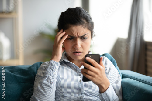Frustrated girl feel stressed with cellphone problems photo