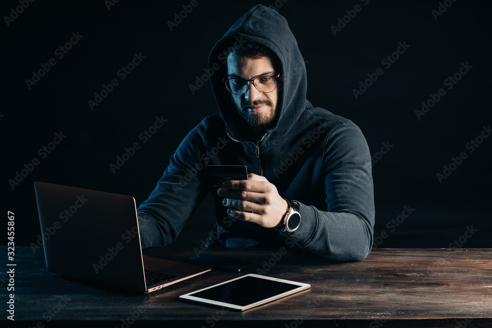 young programming expert hacker going to hack computer system, find password from bank account. terrible crime made by guy in pullover using password cracking algorithm to gain access to a system young programming expert hacker going to hack computer system, find password from bank account. terrible crime made by guy in pullover using password cracking algorithm to gain access to a system