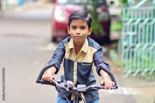 Indian little boy enjoying the cycle ride