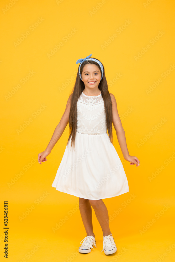 Cute girly girl. Happy girl yellow background. Fashion look of small girl. Little girl wear long brunette hair. Beauty salon. Fashion and style. Shop kids clothing and baby clothes. Girls day Cute girly girl. Happy girl yellow background. Fashion look of small girl. Little girl wear long brunette hair. Beauty salon. Fashion and style. Shop kids clothing and baby clothes. Girls day