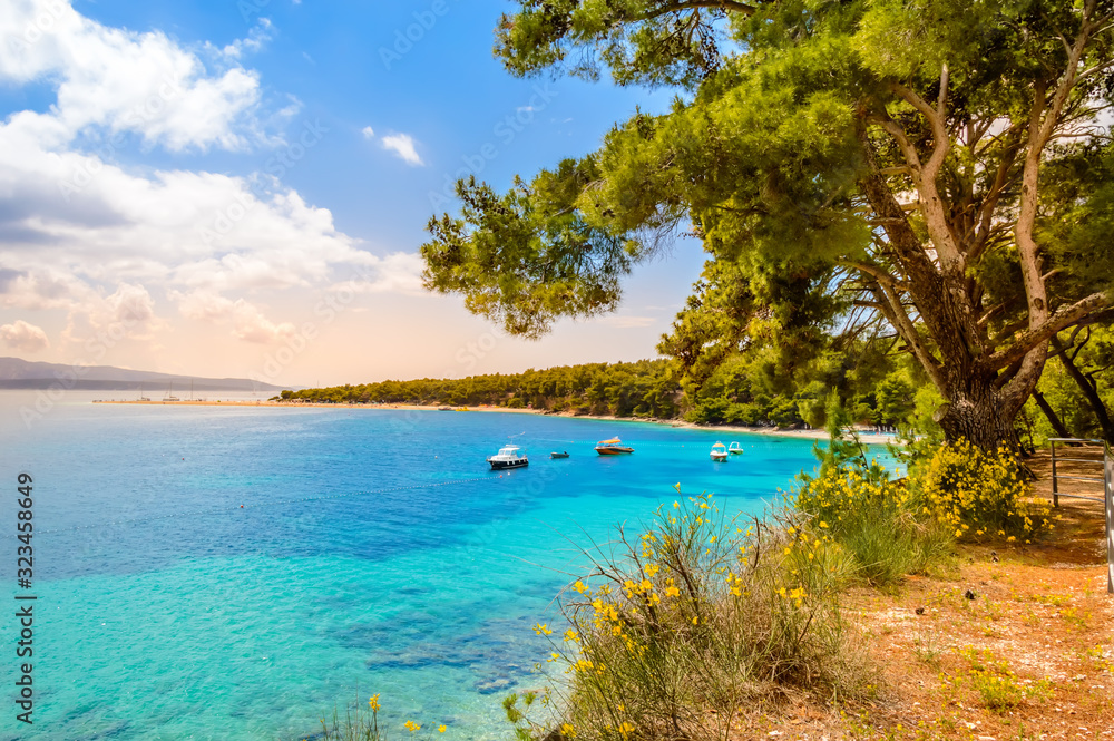 Zlatni Rat beach or Golden Horn in Bol town on Brac Island, Croatia. Scenic pebble beach with pine trees and turquoise sea water - obrazy, fototapety, plakaty 