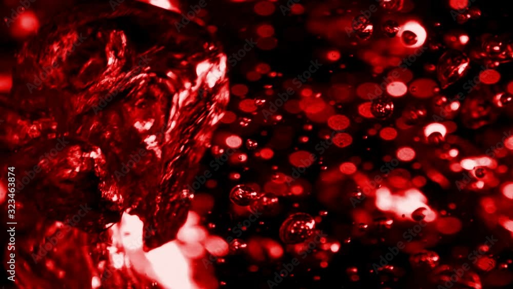 Slow Motion Video: The chaotic slow motion of air bubbles inside boiling water. Abstract blood-red background with moving and vibrating volume bubbles, blurry spots and bright highlights Slow Motion Video: The chaotic slow motion of air bubbles inside boiling water. Abstract blood-red background with moving and vibrating volume bubbles, blurry spots and bright highlights