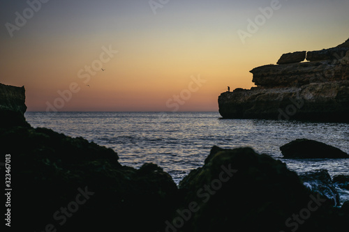 Orange tropical sunset with rock formations