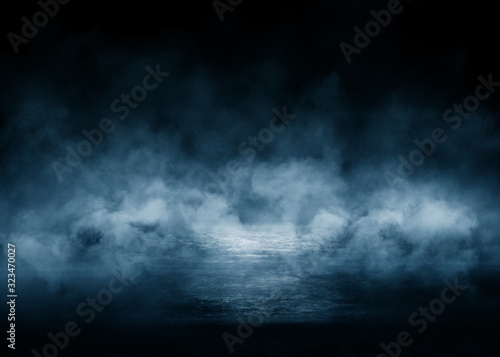 Dark blue abstract futuristic background. Laser neon rays. Neon light, reflection on the asphalt, smoke, smog photo