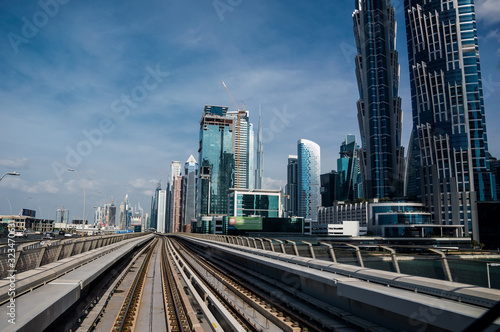 A view of a metro station from the train's rear window on the Dubai Metro.