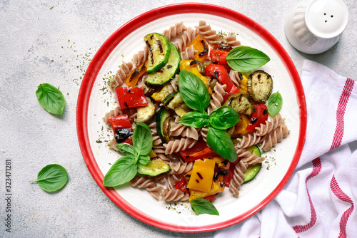 Whole grain pasta with grilled vegetables. Top view with copy space. photo