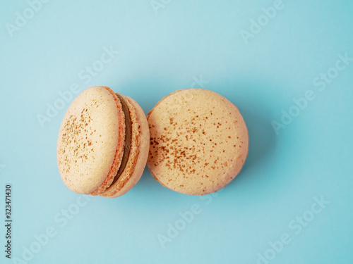 French macarons isolated on blue background.