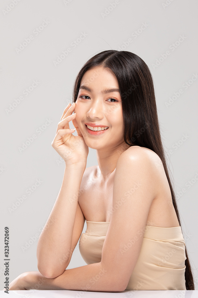 Asian young woman touching soft cheek smile with clean and fresh skin Asian young woman touching soft cheek smile with clean and fresh skin