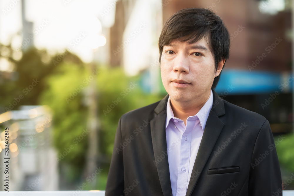 Portrait Korean Businessman in city at sunset Portrait Korean Businessman in city at sunset