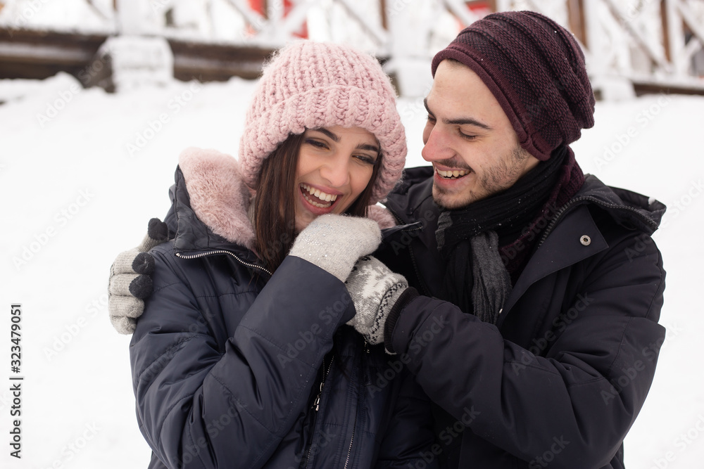 Young couple hugging in the Park in winter. Young couple hugging in the Park in winter.