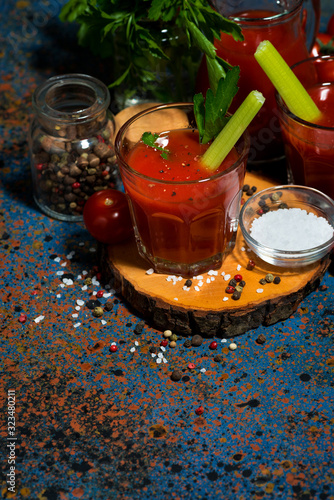 fresh healthy tomato juice with salt and celery, top view