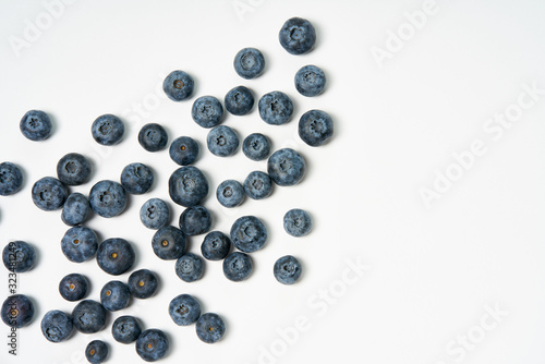 Fresh blueberries sprinkled. Tasty blueberries isolated on white background. Blueberries are antioxidant organic superfood. Tasty blue berries close up. Top view.