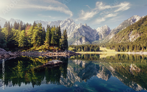 Wonderful Nature landscape. Amazing Mountains lake during sunset. Awesome alpine highlands in sunny day. Picture of wild area. Fusine lake. Italy, Julian Alps. Best travel locations.