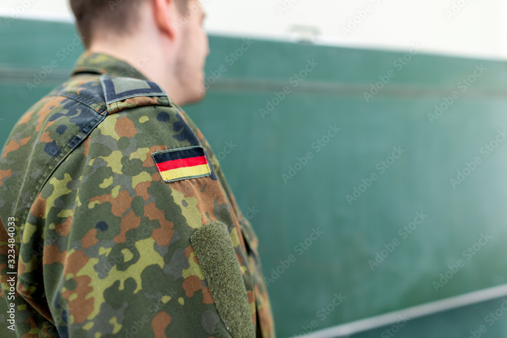 Fototapeta premium German soldier stands in a classroom . German word Bundeswehr, means german army.
