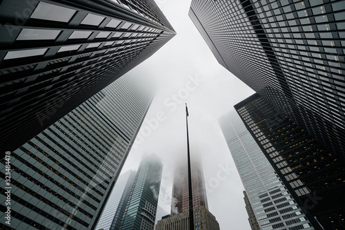Scenic Toronto financial district skyline and modern architecture. Skyscrapers, fog and clouds concept.