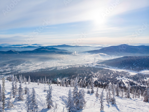 Sheregesh Kemerovo region ski resort in winter, landscape on mountain and hotels, aerial top view