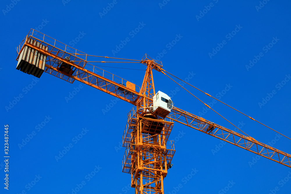 The tower crane is on the construction site. The tower crane is on the construction site.