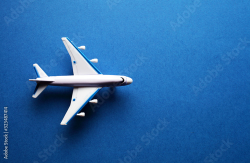toy passenger plane on a blue background with place for your text